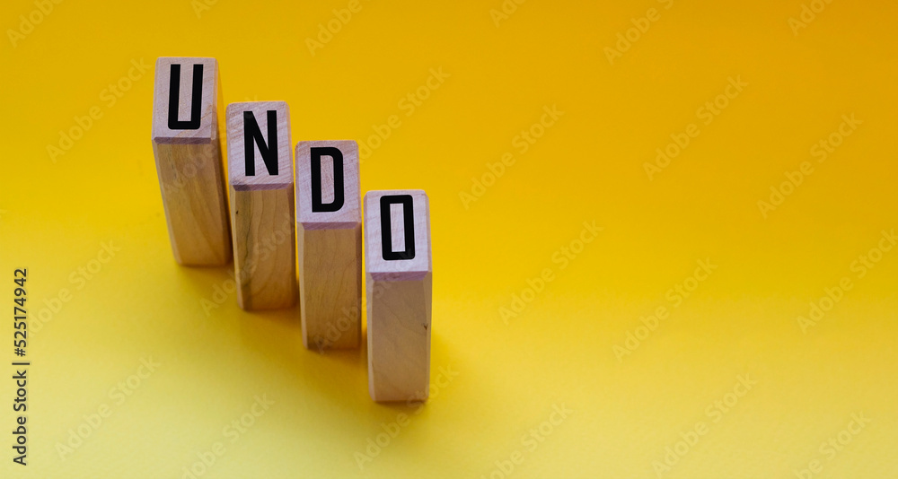 Fototapete undo word on wooden cubes with letters on yellow background. the concept of a computer program techn