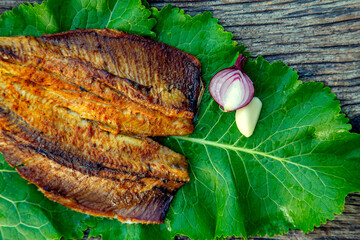 Sea fish cooked on the barbecue. Sea fish fillet baked on the grill. The concept of folk cuisine, restaurant, cooking.