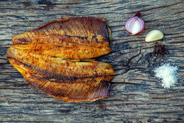 Sea fish cooked on the barbecue. Sea fish fillet baked on the grill. The concept of folk cuisine, restaurant, cooking.