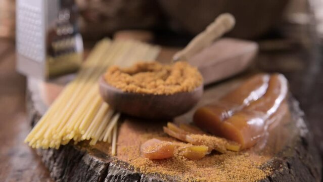 Bottarga, dried roe of mullet. Sardinian Food. FOR A dish with traditional Italian pasta from the South, dried sardine roe, and thin pasta. High quality footage