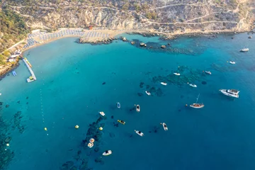 Foto op Canvas Drone aerial seascape with luxury yachts moored in the coast and unrecognised people swimming and relaxing. Summer vacations konnos bay Ayia napa Cyprus © Michalis Palis