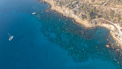 Fototapeta na wymiar Drone aerial seascape with yacht moored in the coast. Summer vacations in the sea. Ayia Napa Cyprus