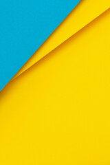 Abstract color papers geometry flat lay composition background with light blue and bright yellow tones