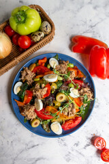 nicoise salad with tuna on the table with vegetables top view