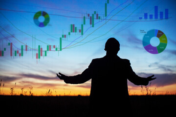Silhouette of a man - economist, big player at sunset who influences the stock market. Businessman keeping the growth in economy. Market manipulator