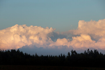 sunset in the mountains with big cumulus clouds