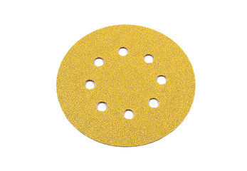 Sandpaper with a rough part of yellow color, in the shape of a circle.
