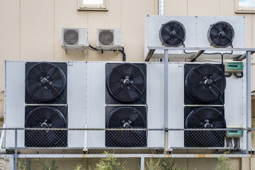 Industrial ventilation. Large air conditioners on wall. External blocks from Industrial ventilation. lots fans from conditioners. HVAC and split technology. Sale industrial air conditioners concept