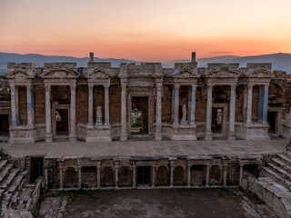 Obraz premium Amphitheater in the ancient city of Hierapolis in the afternoon. Unesco Cultural Heritage Monument. Pamukkale, Turkey 15.07.2022