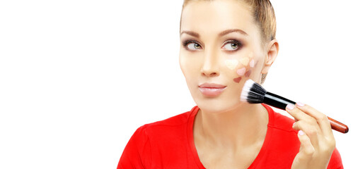 Applying Make-up. Woman with a brush for make-up.Shades of makeup powder on white background.