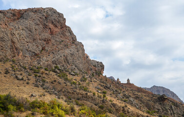 Fototapeta na wymiar Road through canyon with admire the Noravank Monastery as it appears high on the cliff, landmark of Armenia