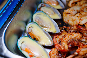 Chafing Dish with assorted grilled mussels and shrimps