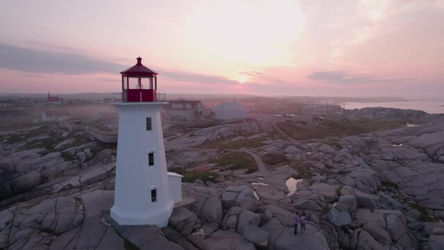 Peggy's Cove Lighthouse in Nova Scotia Canada at Sunrise - Aerial Drone Footage