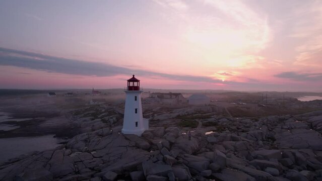 Peggy's Cove Lighthouse in Nova Scotia Canada at Sunrise - Aerial Drone Footage