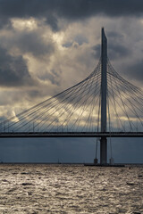 new cable-stayed bridge over the Neva River in St. Petersburg at sunset, dramatic sky in the background