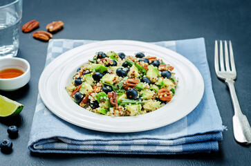 Quinoa avocado blueberry pecan salad with maple syrup lime dressing in a plate