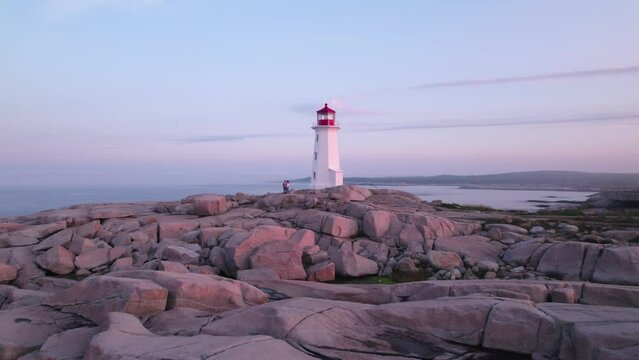 Peggy's Cove Lighthouse in Nova Scotia Canada at Sunrise - Aerial Drone Footage