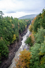 fall in Vermont looking down at a river with fall colors