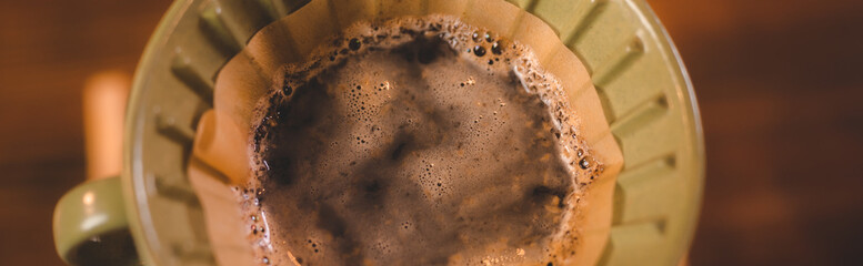 hipster barista pouring a hot water to making coffee with drip or filter style in cafe, slow brew...