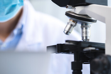 biotechnology scientist using scientific microscope for research in biology medicine laboratory, equipment for chemistry science or microbiology analysis in term of medical technology experiment
