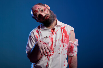 Scary undead zombie looking crazy evil, having blood on shirt and dangerous aggressive bloody look. Eerie apocalyptic corpse with ugly dirty scars and wounds, brain eating demon. © DC Studio