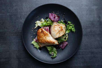 Grilled chicken breast with salad on plate