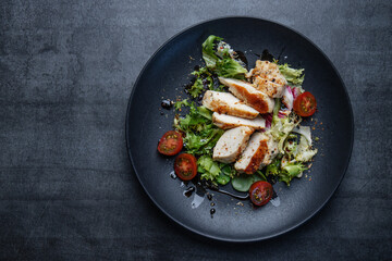 Grilled chicken breast with salad on plate