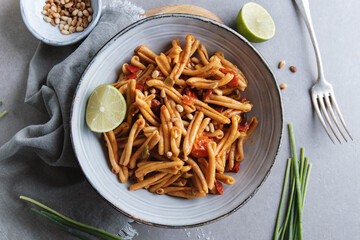 Healthy pasta with tomatoes and pine nuts