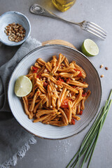 Healthy pasta with tomatoes and pine nuts