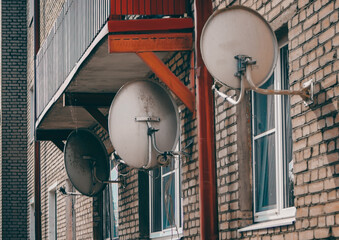 old satellite dishes hanging on the wall