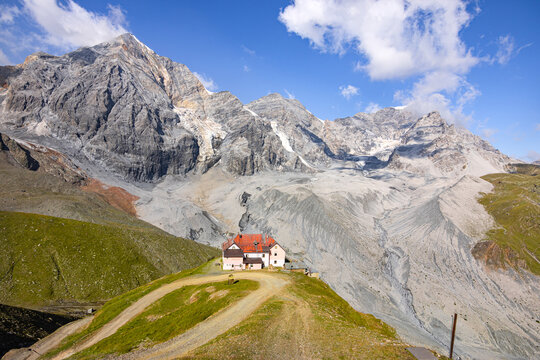 Panoramic view to Peaks Ortles, Zebru and mountain refuge Schaubachh&uuml;tte (Rifugio Citta di Milano) seen from the top station of cableway at Sulden (Solda), South Tyrol, Italy; climate change concept;