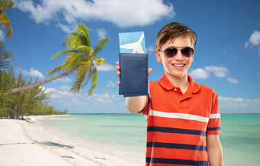 travel, tourism and people concept - portrait of happy smiling boy in sunglasses and red polo...