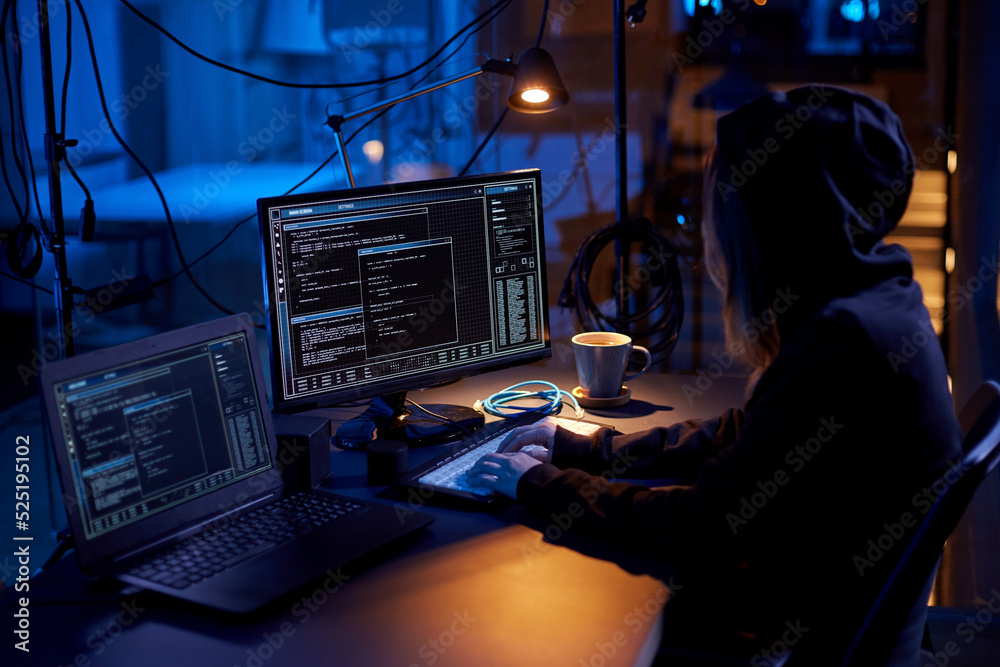Poster cybercrime, hacking and technology concept - female hacker in dark room writing code or using comput