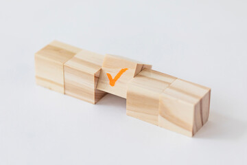 wooden block with check mark on white background