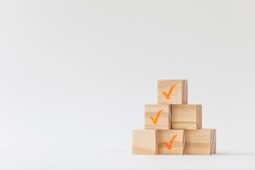 wooden block with check mark on white background