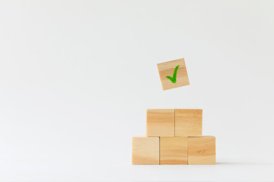 Wooden Block With Check Mark On White Background