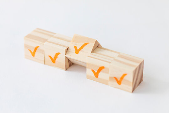 Wooden Block With Check Mark On White Background