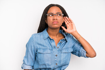 black young adult woman looking serious and curious, listening, trying to hear a secret...