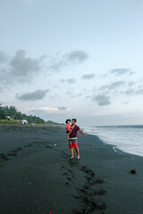 father and daughter admiring the sea with pastel tones and smile