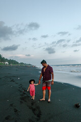 father and daughter admiring the sea with pastel tones and smile