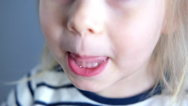child, girl 2 years old, close-up of part of child's face, children's mouth open, concept of sensory feelings, speech disorders, correction, methods of correctional developmental exercises