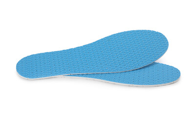 Pair of light blue insoles on white background