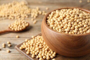 Natural soy beans on wooden table, closeup. Space for text