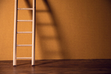 wooden ladder on brown wall background