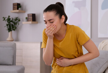 Young woman suffering from nausea at home. Food poisoning - obrazy, fototapety, plakaty