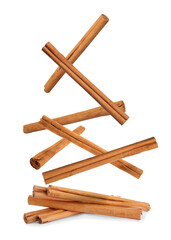 Aromatic dry cinnamon sticks falling on white background