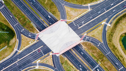 From above, aerial view of a new interchange in the city of Leesburg, Virginia. Modern building design of the roadway to avoid traffic jams. Few cars.