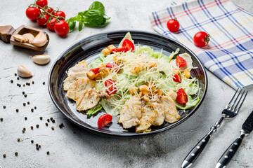 Salad caesar with chicken on grey table