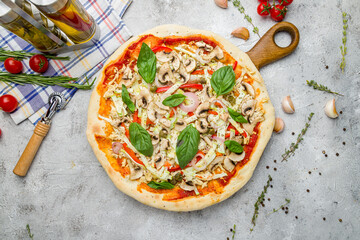 Pizza with vegetables and basil with tomato sauce, vegetarian pizza on grey table top view