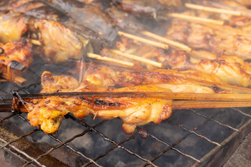 Grilled chicken skewers on stove. Thai food